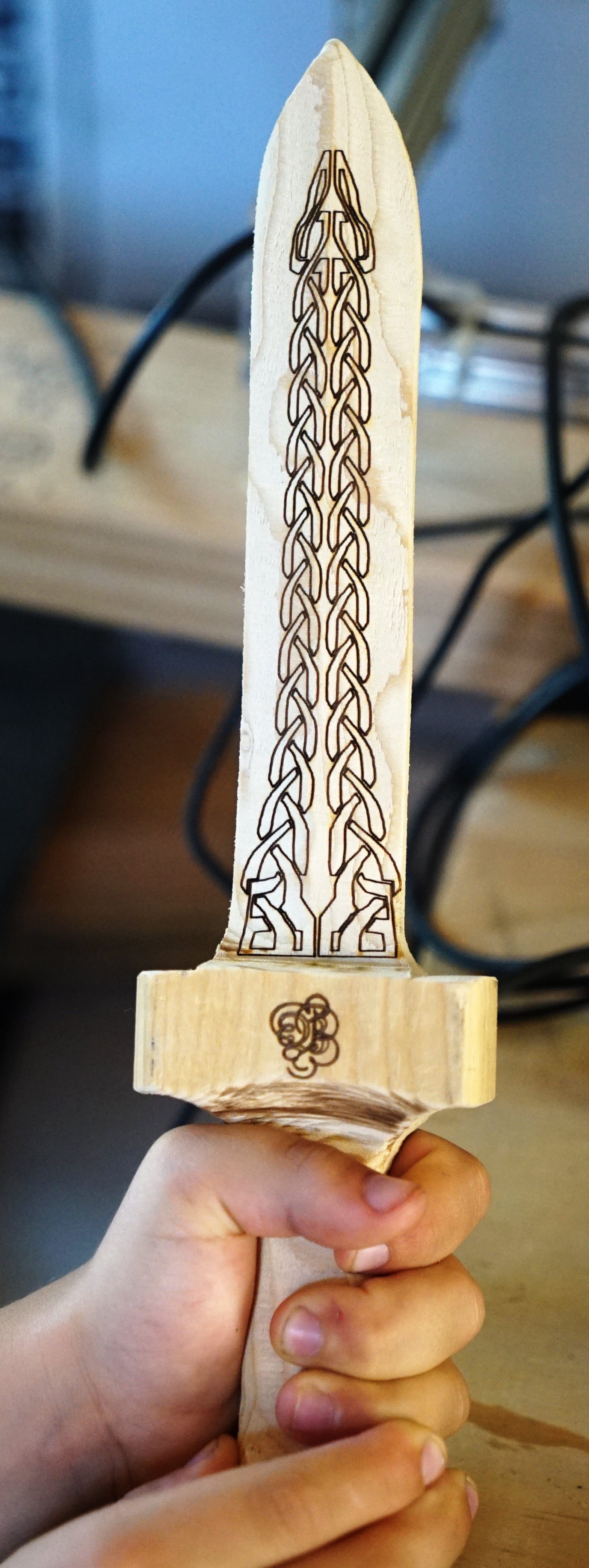 A custom wood heavy dagger with custom celtic knot and monogram laser engraving. Contact us at tryop.com for pricing on custom pieces like this.